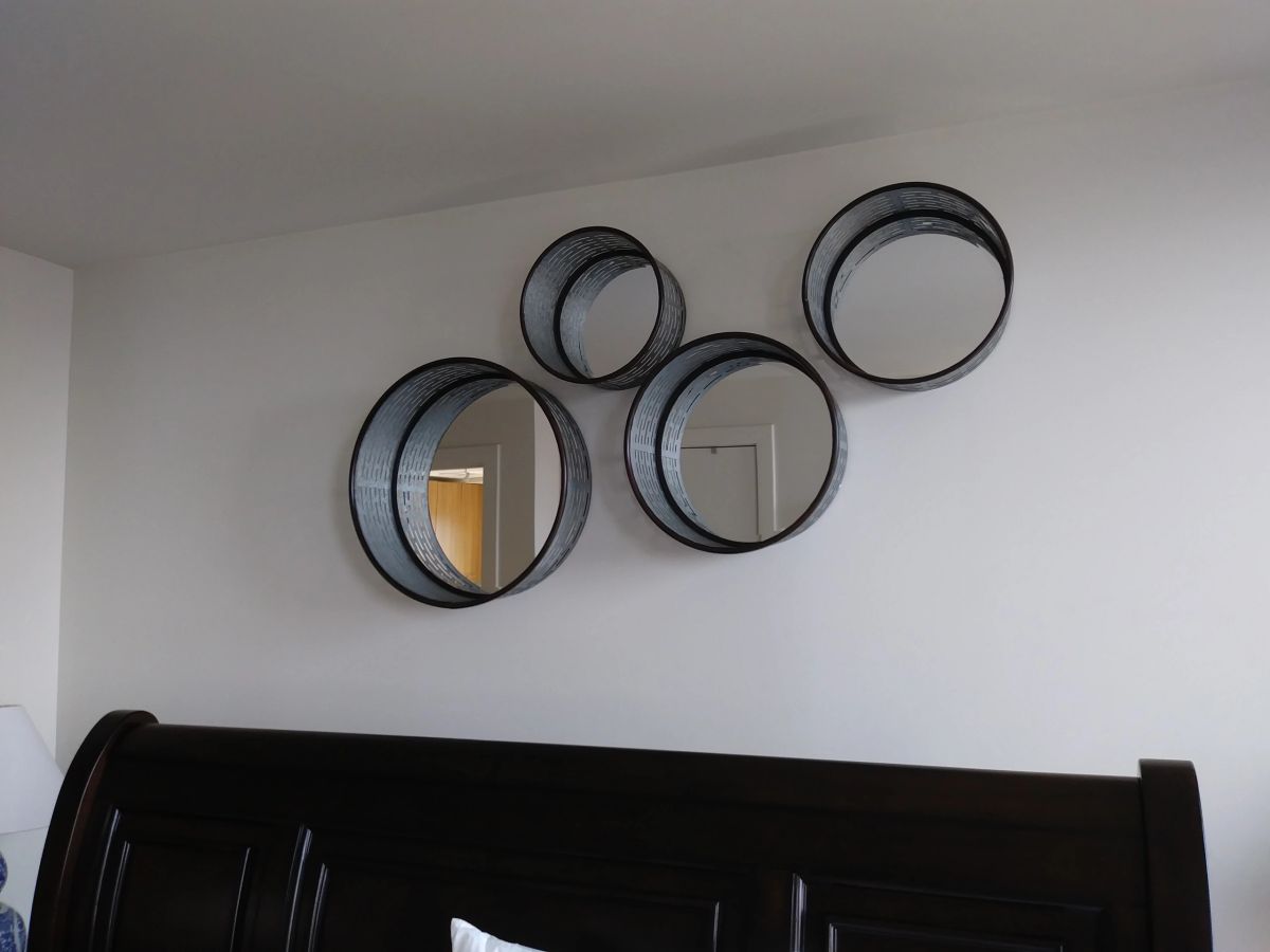 A cluster of framed pictures mounted on a wall