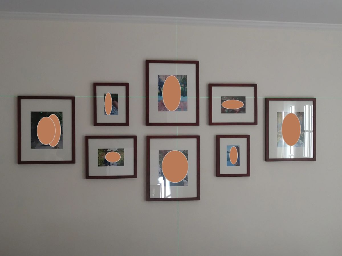Eight framed pictures arranged on a wall